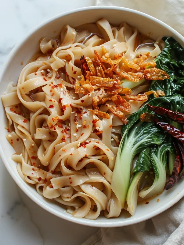 Hand-pulled noodles dough being stretched showing proper gluten development