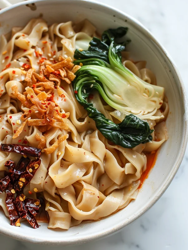 Step-by-step process of making hand-pulled noodles showing dough stretching technique