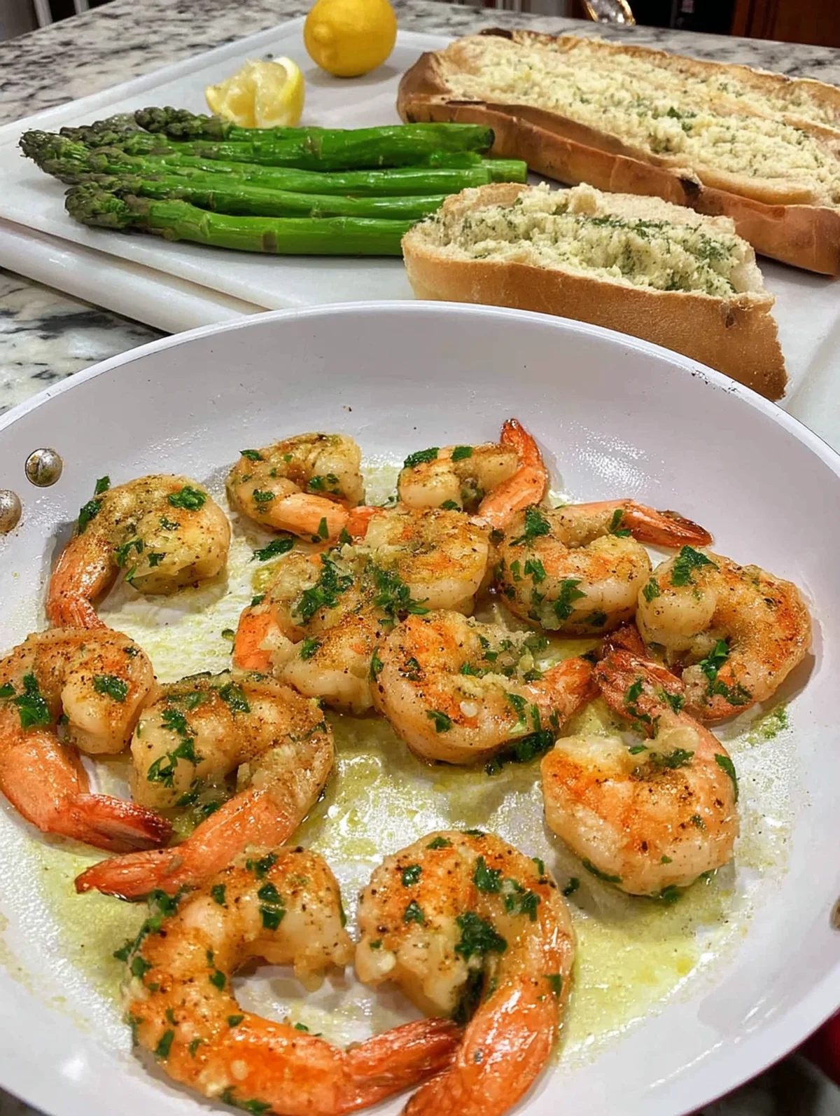 Lemon garlic butter shrimp recipe plated and ready to serve with lemon wedges on the side