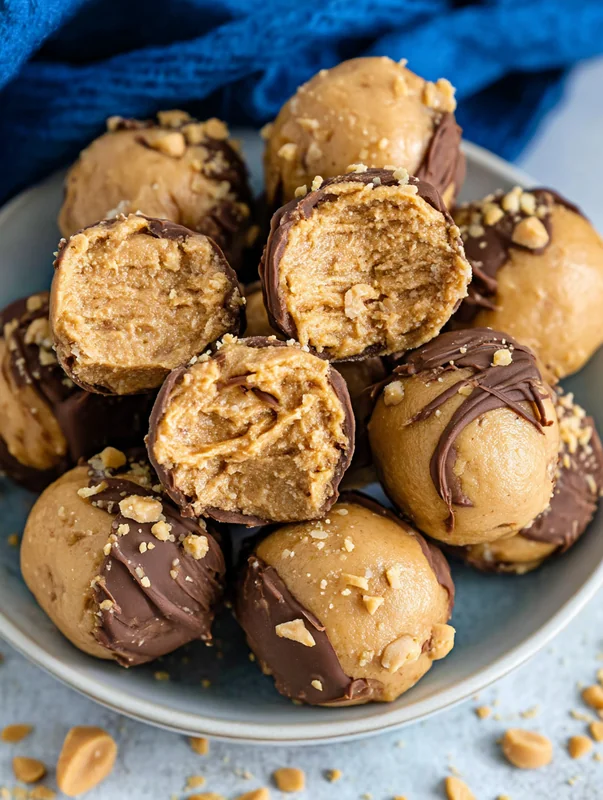 peanut butter balls recipe rolled balls on parchment paper (Peanut Butter Balls Recipe)